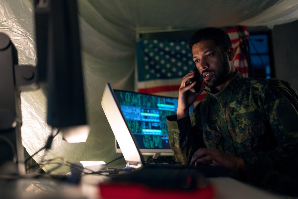 American hacker in military unifrorm on dark web, cyberwar concept.